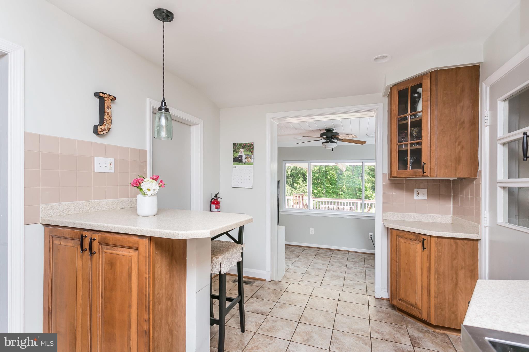 13902 Baldwin Mill Road Baldwin, MD 21013 - Photo 15 of 30 a kitchen with stainless steel appliances kitchen island granite countertop a table chairs in it and wooden floors