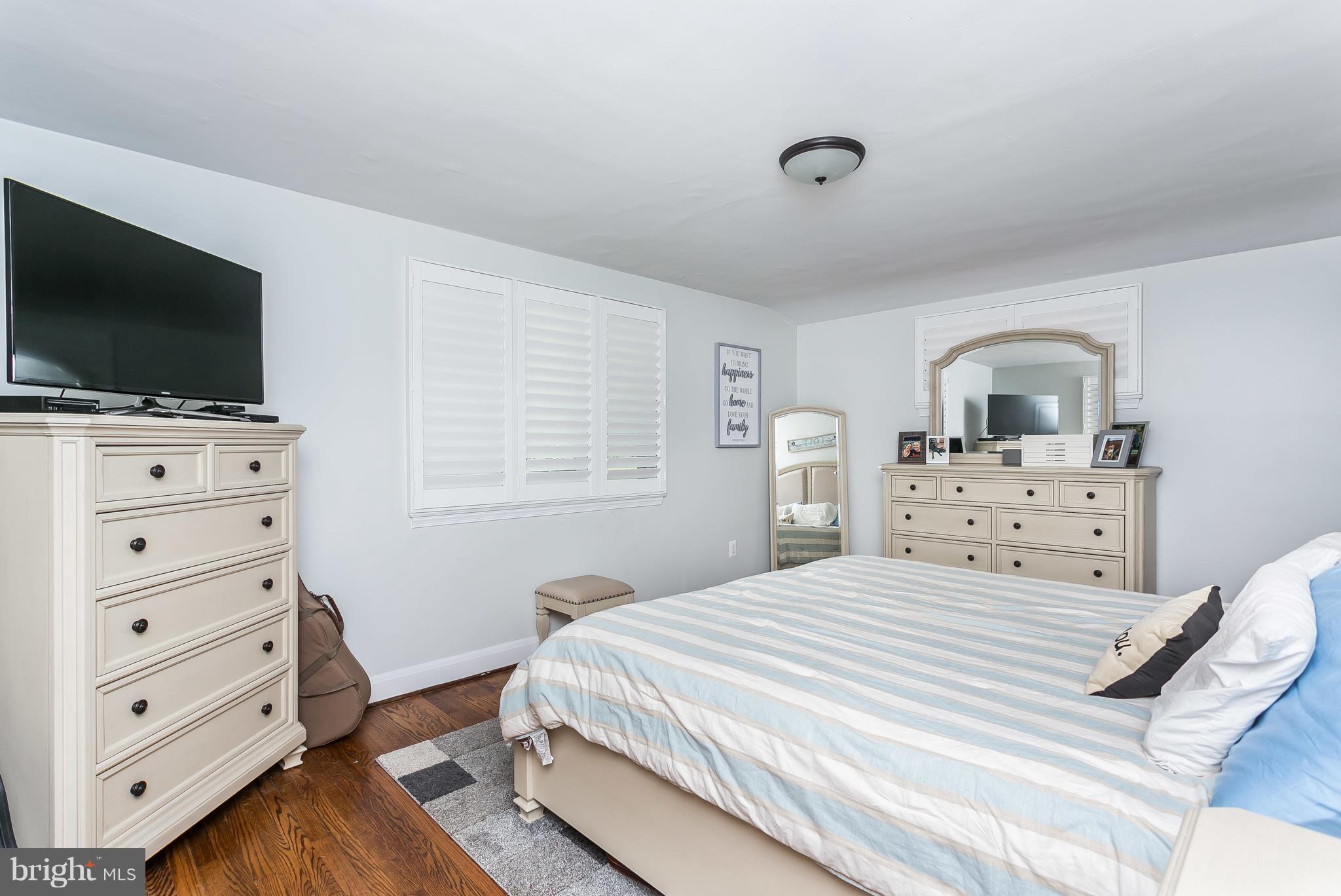 13902 Baldwin Mill Road Baldwin, MD 21013 - Photo 22 of 30 a bedroom with a bed and a flat screen tv