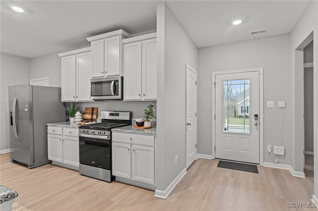 15624 Cedarville Drive Midlothian, VA 23112 - Photo 8 of 49 a kitchen with white cabinets and stainless steel appliances
