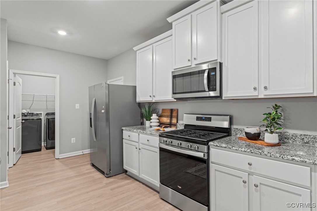 15624 Cedarville Drive Midlothian, VA 23112 - Photo 9 of 49 a kitchen with granite countertop a refrigerator stove and cabinets