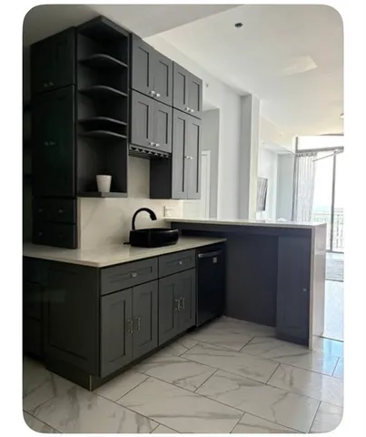 a kitchen with a sink and cabinets