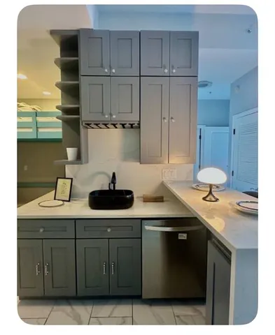 a kitchen with stainless steel appliances a sink dishwasher stove and cabinets