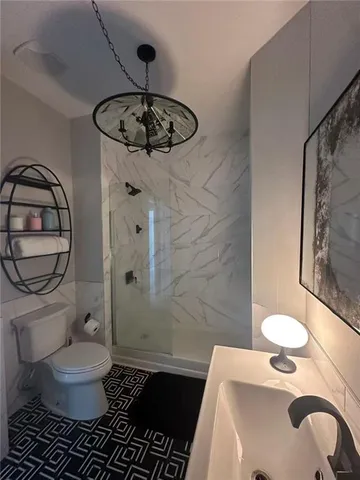 a bathroom with a sink toilet and shower