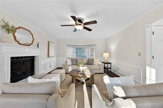 a living room with furniture a fireplace and a chandelier