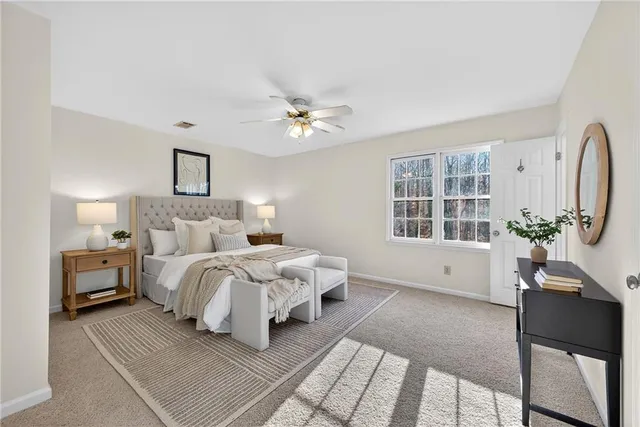 a bed room with a bed and a chair