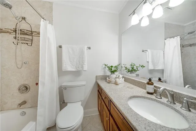 a bathroom with a granite countertop shower sink vanity mirror and toilet