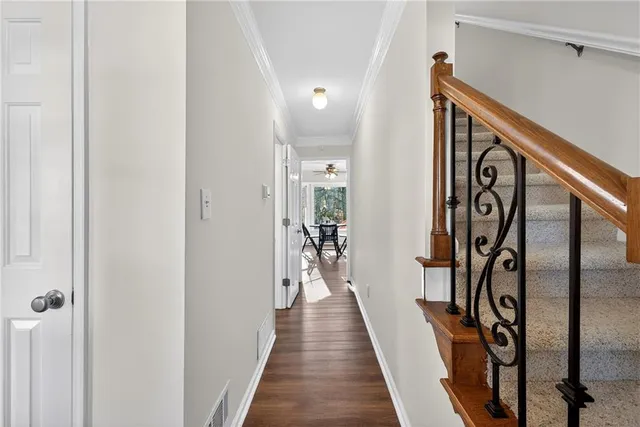 a view of a hallway with wooden floor