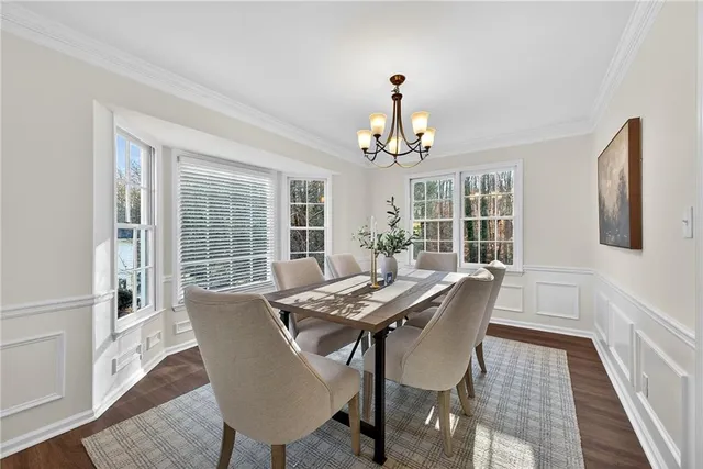 a view of a dining room with furniture wooden floor and a chandelier