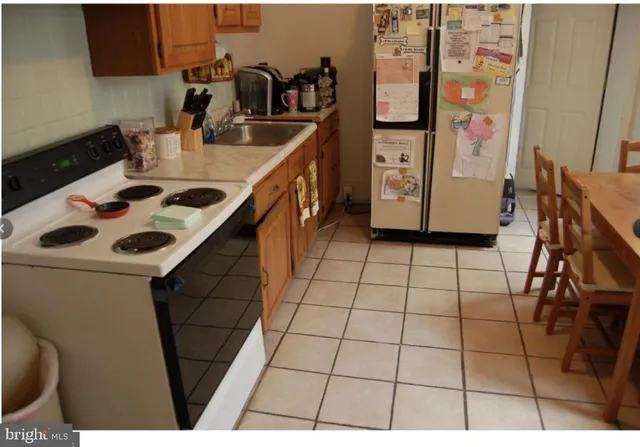 a kitchen with a sink a stove and cabinets