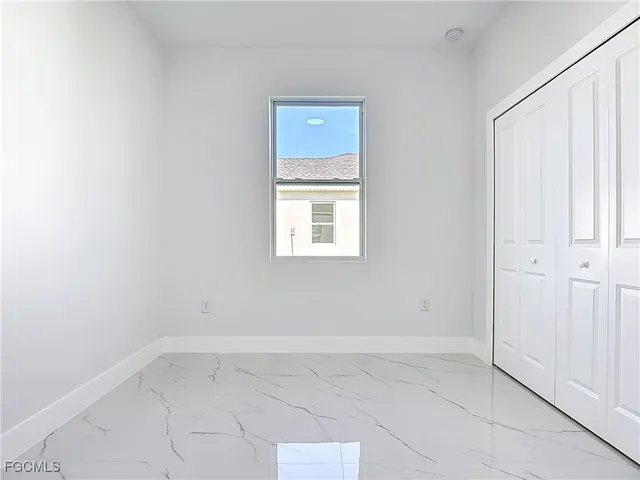 a bathroom with a granite countertop bathtub shower sink vanity and toilet