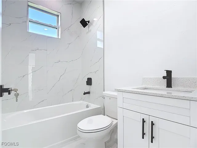 a view of a kitchen with white cabinets