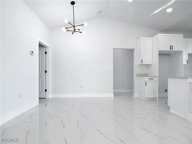 a view of a kitchen with a refrigerator and a sink