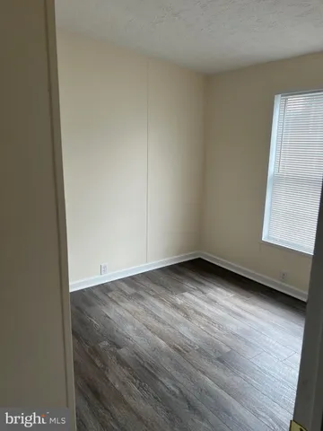 a view of an empty room and wooden floor