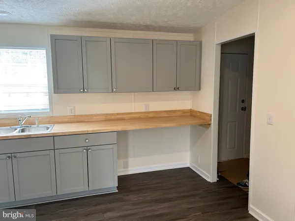 a kitchen with a sink cabinets and a window