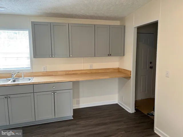 a kitchen with a sink cabinets and a window