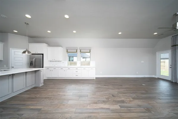 a view of kitchen with microwave and cabinets