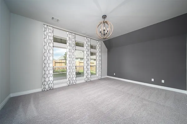 an empty room with a empty space and a large window