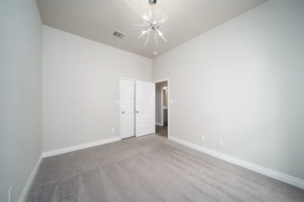 a view of an empty room with a ceiling fan and a window
