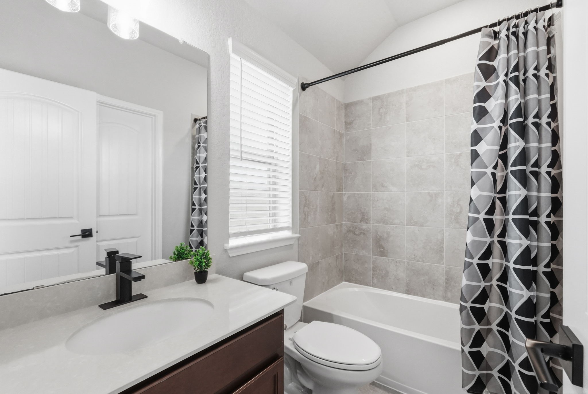 4334 Umber Shadow Drive Spring, TX 77386 - Photo 31 of 45 Secondary bathroom features a vanity with storage, updated fixtures, and a tub-shower combination.