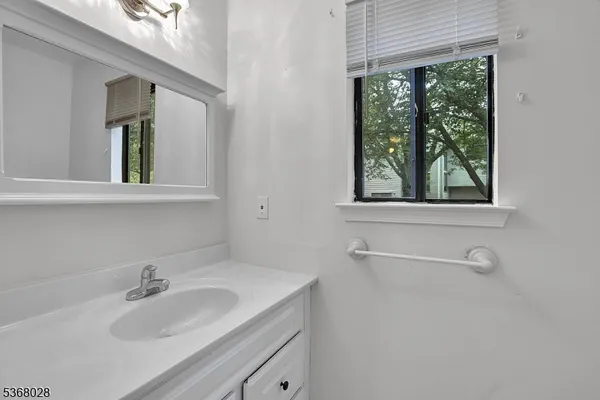 a bathroom with a sink and a window
