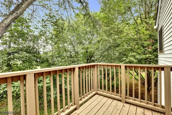 a balcony with wooden floor and fence