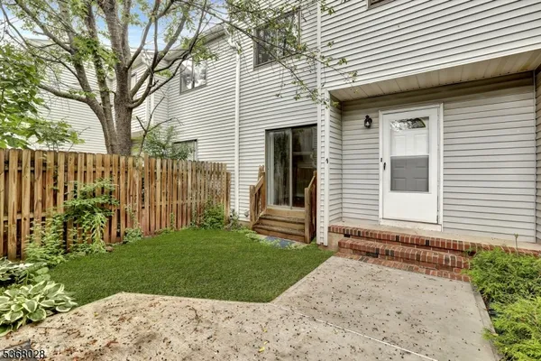 a small white house with a white roof and a yard