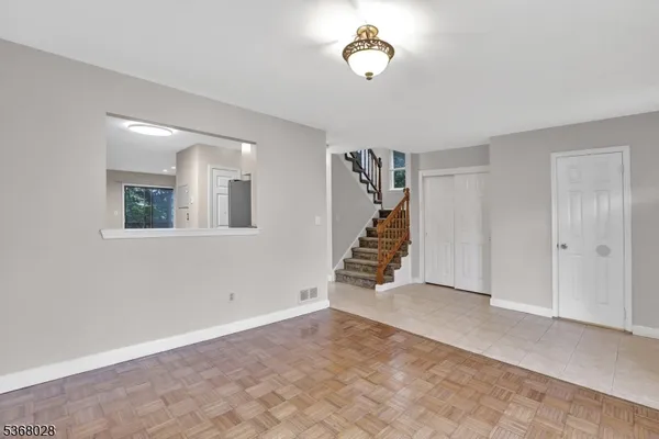 an empty room with windows and stairs
