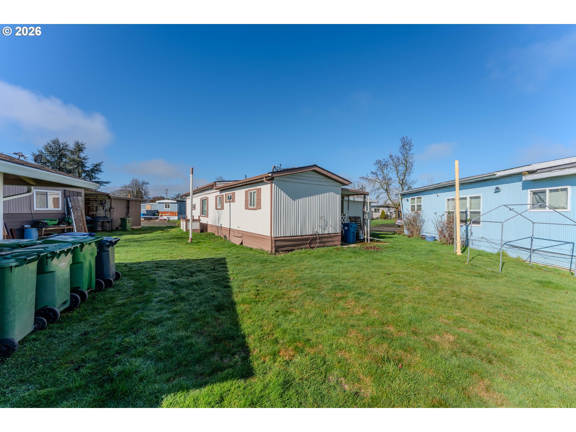 1999 Jansen Way, Unit 66 Woodburn, OR 97071 - Photo 24 of 26 a backyard of a house with table and chairs