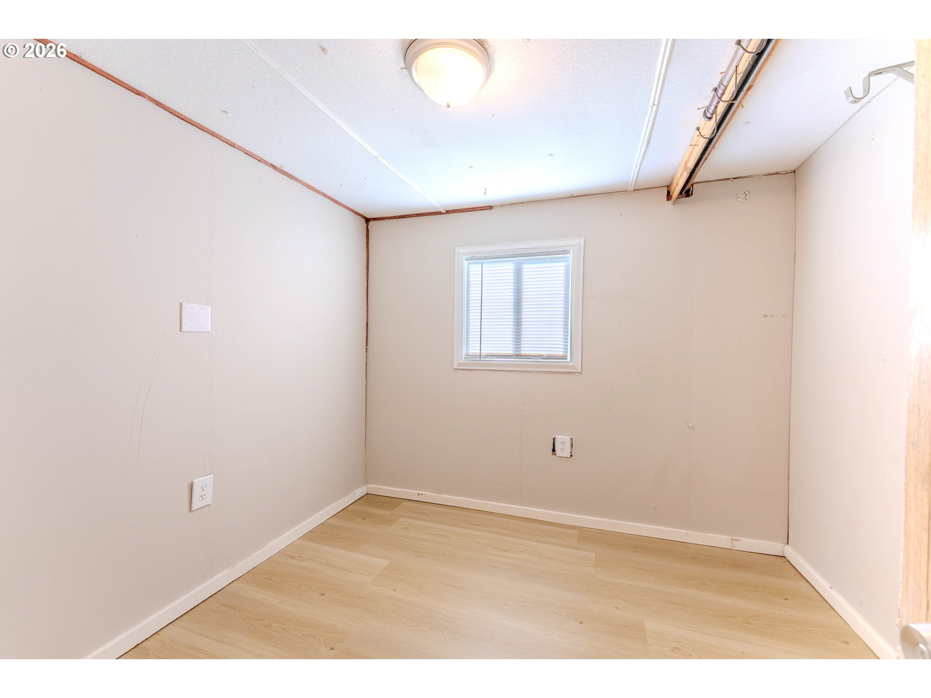 1999 Jansen Way, Unit 66 Woodburn, OR 97071 - Photo 10 of 26 a view of empty room with wooden floor