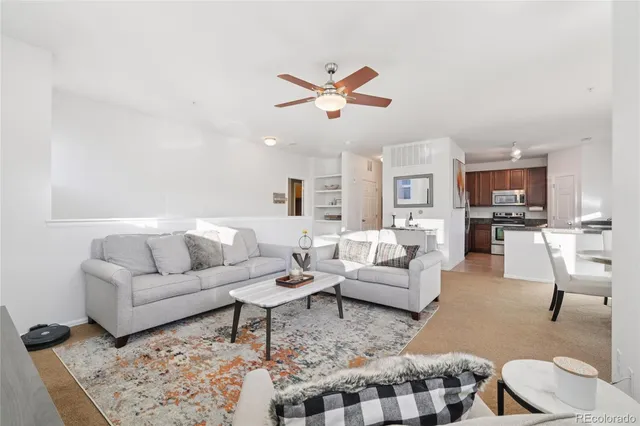 a living room with furniture and kitchen view