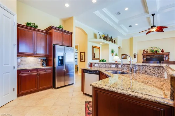a kitchen with stainless steel appliances granite countertop a sink dishwasher stove and refrigerator