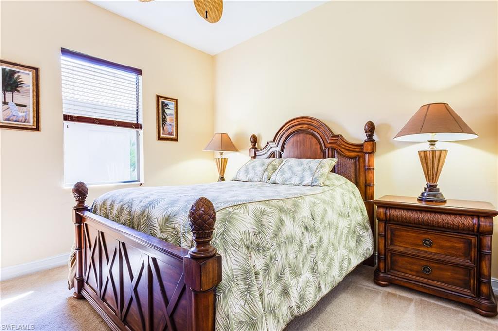 7747 Cottesmore Drive Naples, FL 34113 - Photo 18 of 32 a bedroom with a bed and a dresser