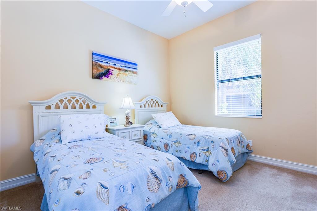 7747 Cottesmore Drive Naples, FL 34113 - Photo 20 of 32 a bedroom with two beds and a window