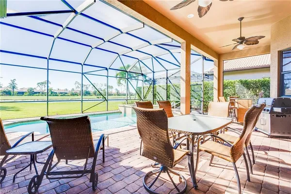 a dining room with furniture and a floor to ceiling window