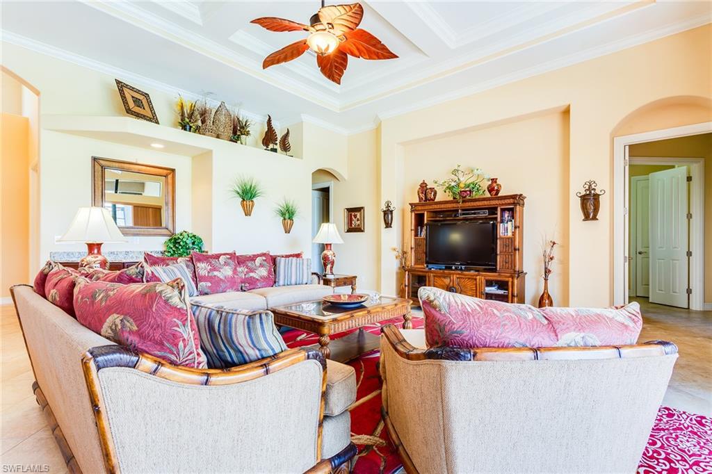 7747 Cottesmore Drive Naples, FL 34113 - Photo 6 of 32 a living room with furniture and a flat screen tv