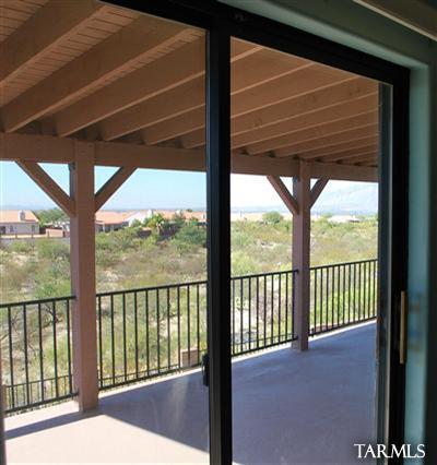 1118 South Riparian Avenue Tucson, AZ 85748 - Photo 6 of 13 a view of a porch with a floor to ceiling window and wooden floor