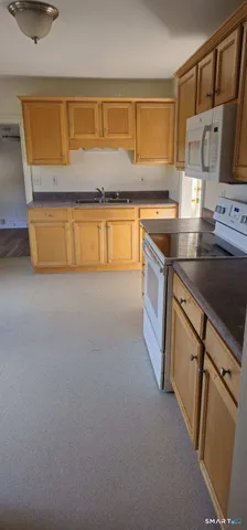 a kitchen with stainless steel appliances granite countertop a sink and a stove