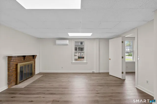 a view of livingroom with hardwood floor and a fireplace