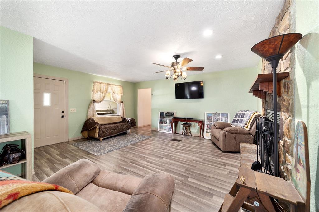 15755 Southwest 90th Avenue Dunnellon, FL 34432 - Photo 14 of 55 a living room with furniture and a chandelier
