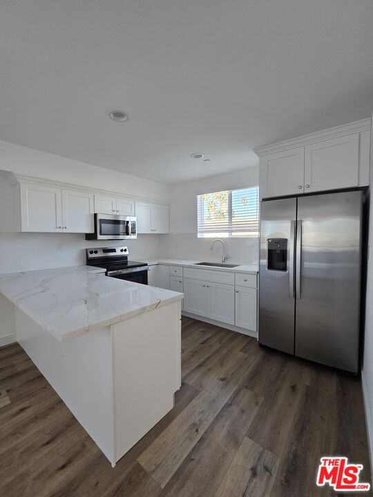 449 West 74th Street Los Angeles, CA 90003 - Photo 3 of 28 a kitchen with stainless steel appliances a refrigerator sink and microwave