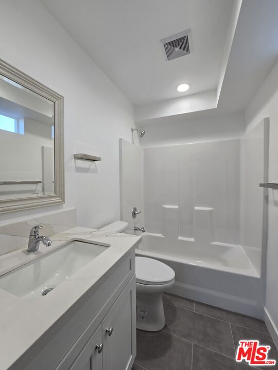 449 West 74th Street Los Angeles, CA 90003 - Photo 8 of 28 a bathroom with a sink a toilet and shower