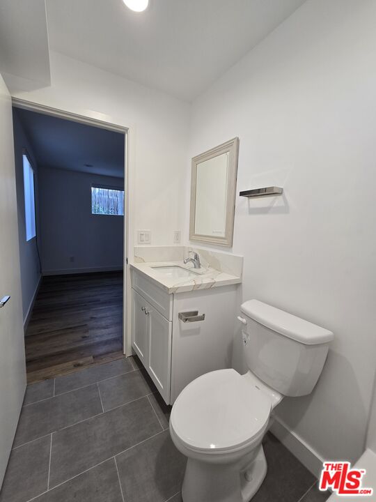 449 West 74th Street Los Angeles, CA 90003 - Photo 9 of 28 a bathroom with a toilet sink and mirror