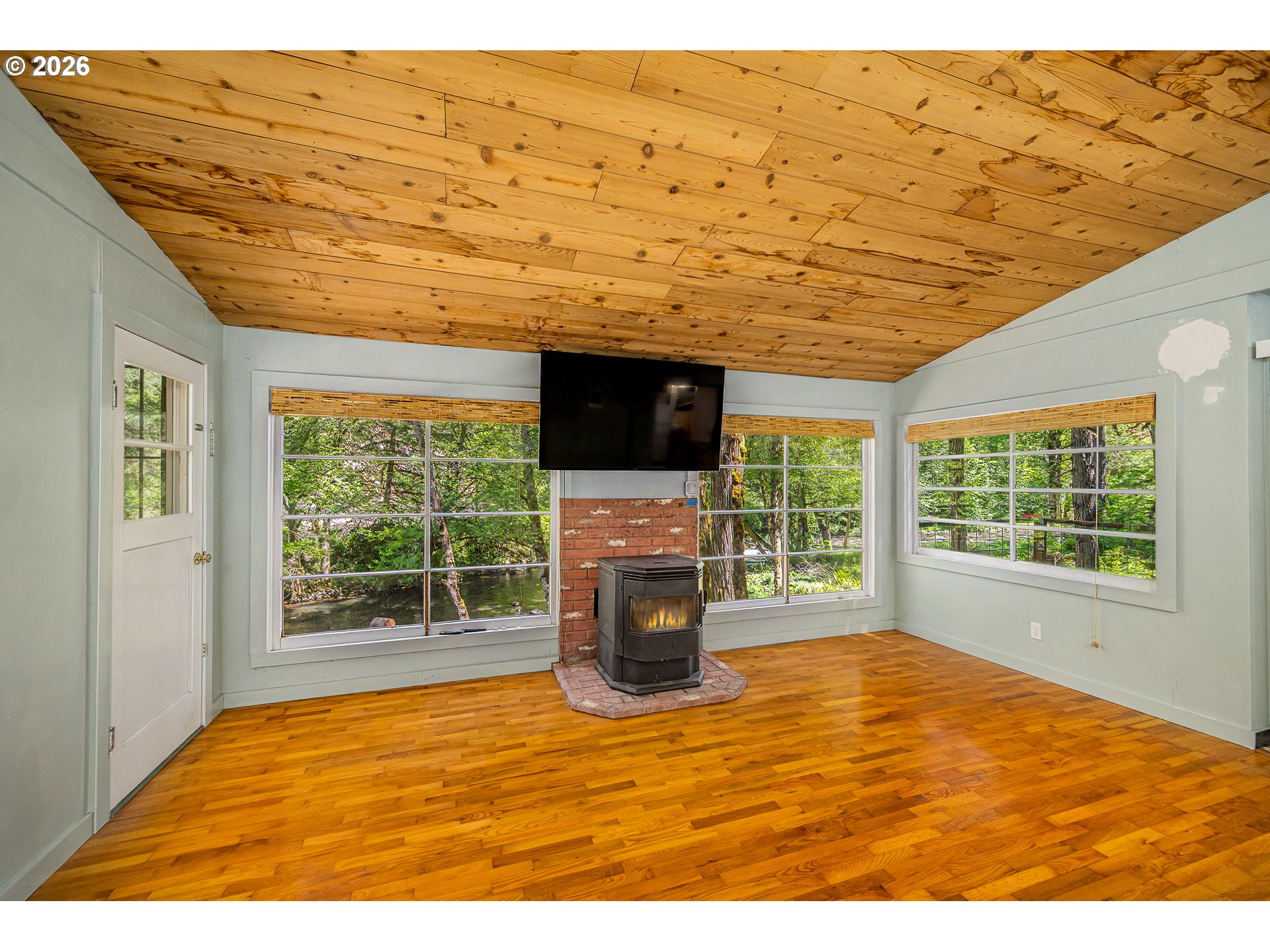 49091 Salt Creek Road Oakridge, OR 97463 - Photo 10 of 16 a view of empty room with wooden floor and fireplace