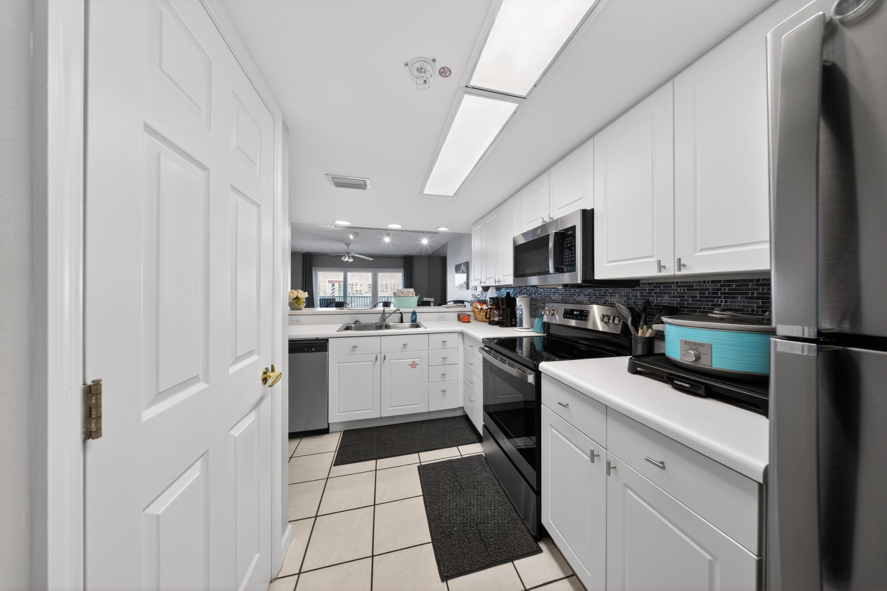 895 Santa Rosa Boulevard, Unit 510 Fort Walton Beach, FL 32548 - Photo 12 of 45 a kitchen with a sink stainless steel appliances and white cabinets