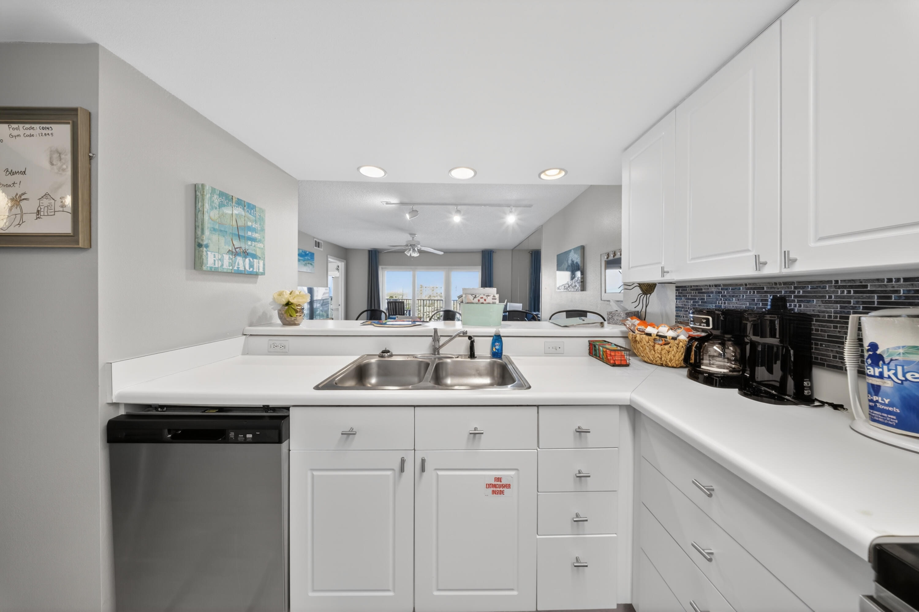 895 Santa Rosa Boulevard, Unit 510 Fort Walton Beach, FL 32548 - Photo 13 of 45 a kitchen with stainless steel appliances kitchen island granite countertop a sink and cabinets