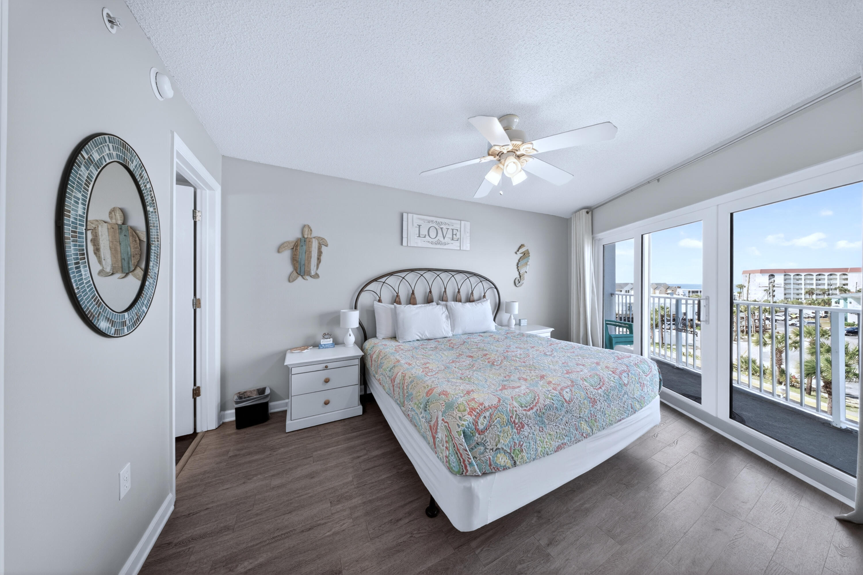 895 Santa Rosa Boulevard, Unit 510 Fort Walton Beach, FL 32548 - Photo 18 of 45 a spacious bedroom with a bed a mirror and a window