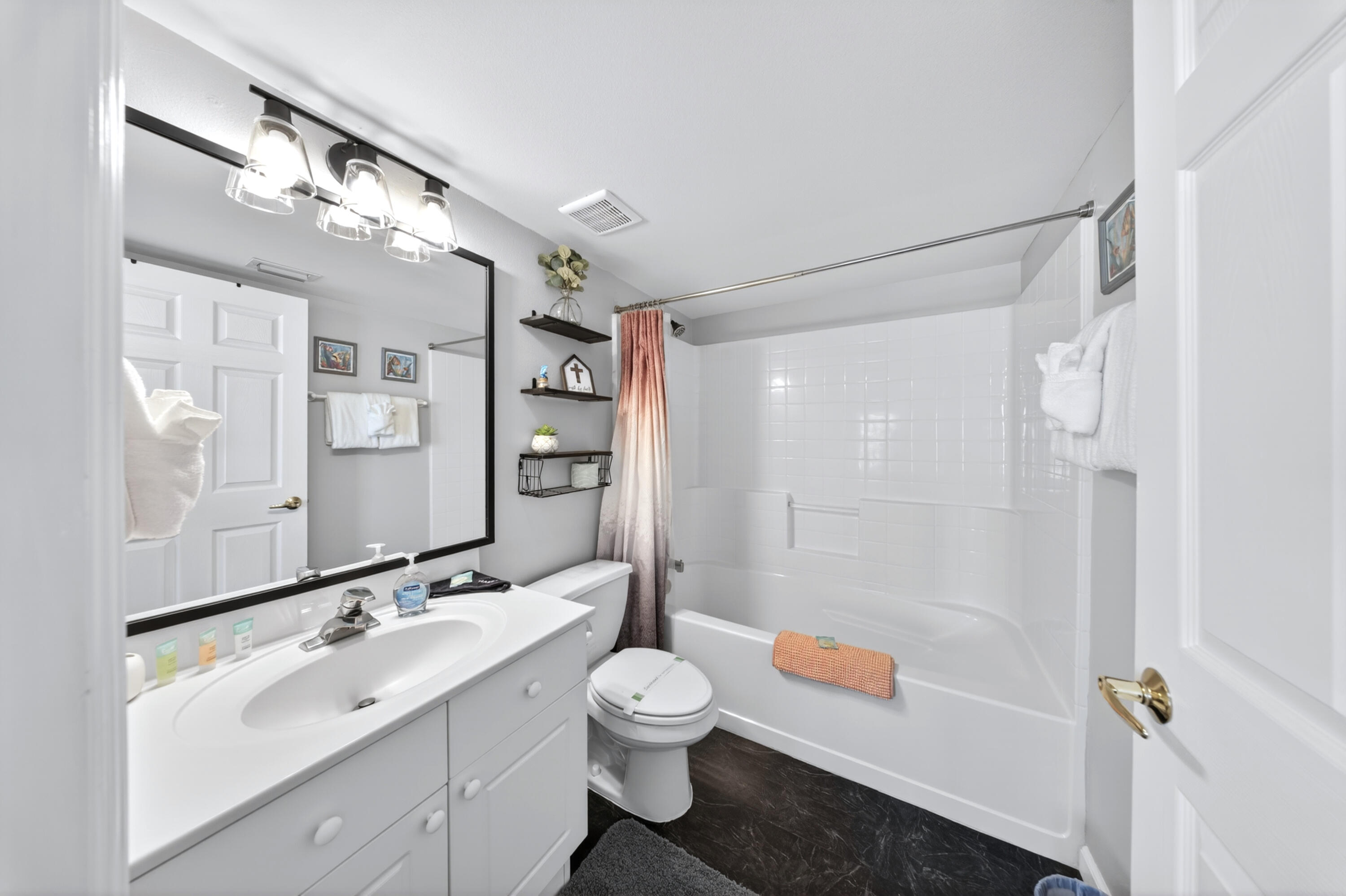 895 Santa Rosa Boulevard, Unit 510 Fort Walton Beach, FL 32548 - Photo 26 of 45 a bathroom with a double vanity sink toilet mirror and shower