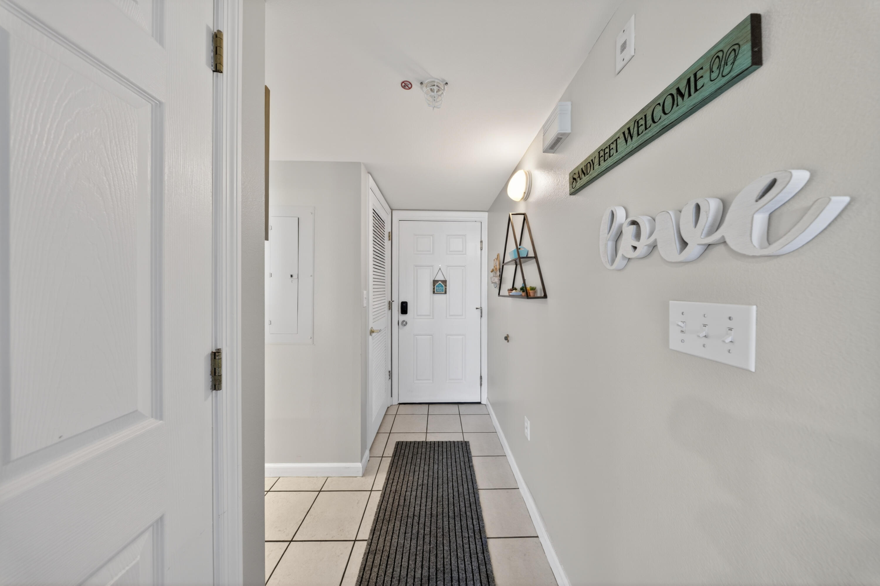 895 Santa Rosa Boulevard, Unit 510 Fort Walton Beach, FL 32548 - Photo 6 of 45 a view of a hallway with wooden floor
