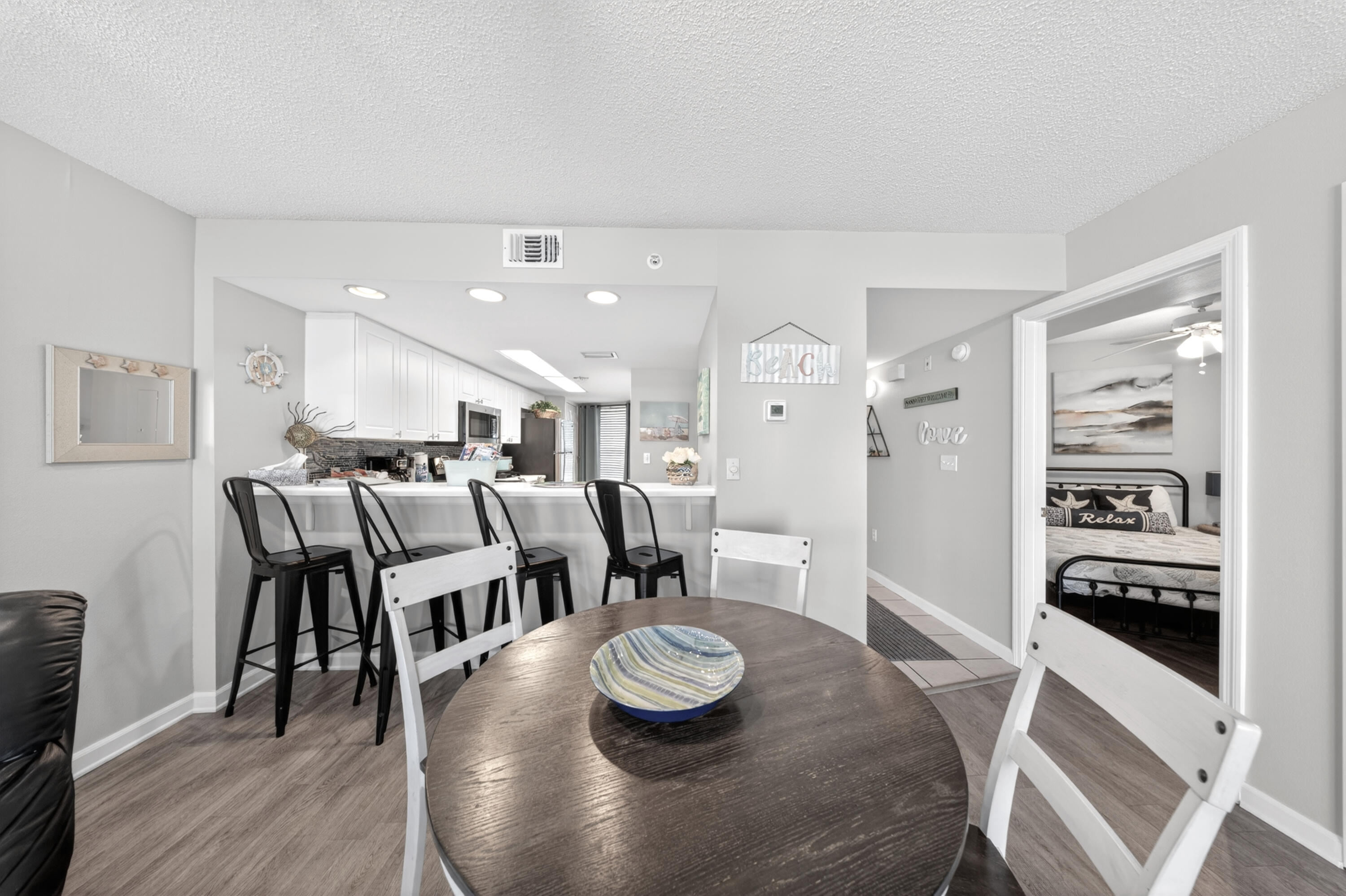 895 Santa Rosa Boulevard, Unit 510 Fort Walton Beach, FL 32548 - Photo 8 of 45 a kitchen with stainless steel appliances granite countertop a table chairs stove and wooden floor