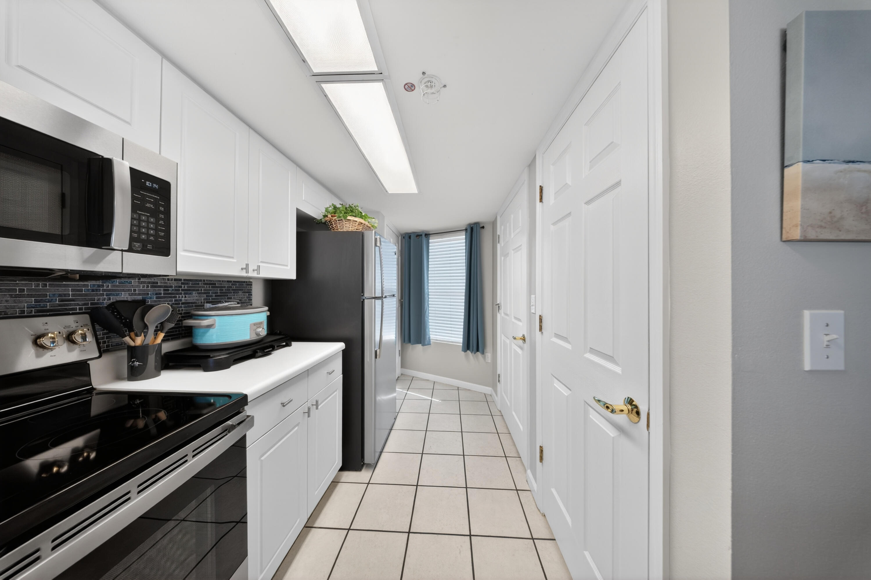 895 Santa Rosa Boulevard, Unit 510 Fort Walton Beach, FL 32548 - Photo 10 of 45 a kitchen with stainless steel appliances a stove microwave and cabinets
